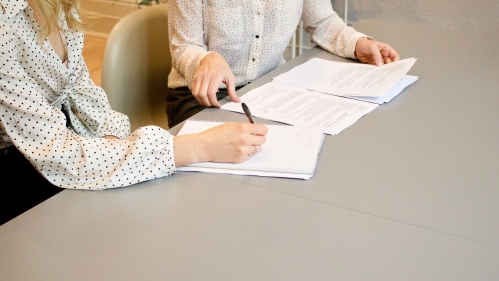 Two people reviewing documents