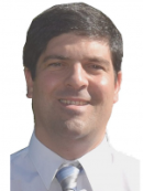 headshot of man with short dark brown hair wearing a white shirt with a tie
