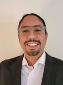 male with glasses and black jacket