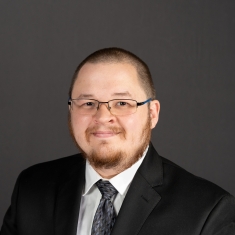 male in black suit