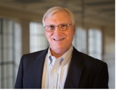 male in black suit jacket wearing glasses
