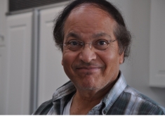 male with black hair and frameless glasses