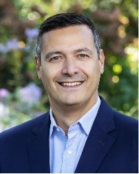 male in suit with blue shirt